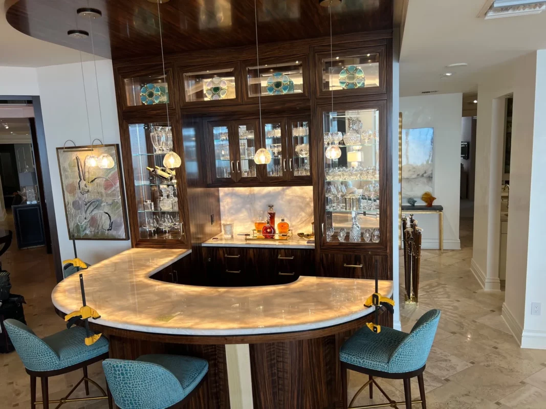 Curved bar remodel with an illuminated counter and display cabinetry.