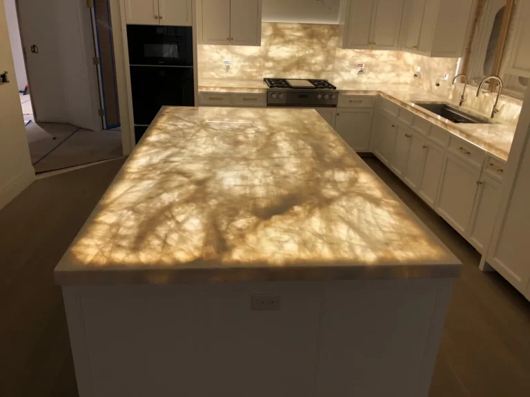 Kitchen remodel with an illuminated island and matching backsplash.