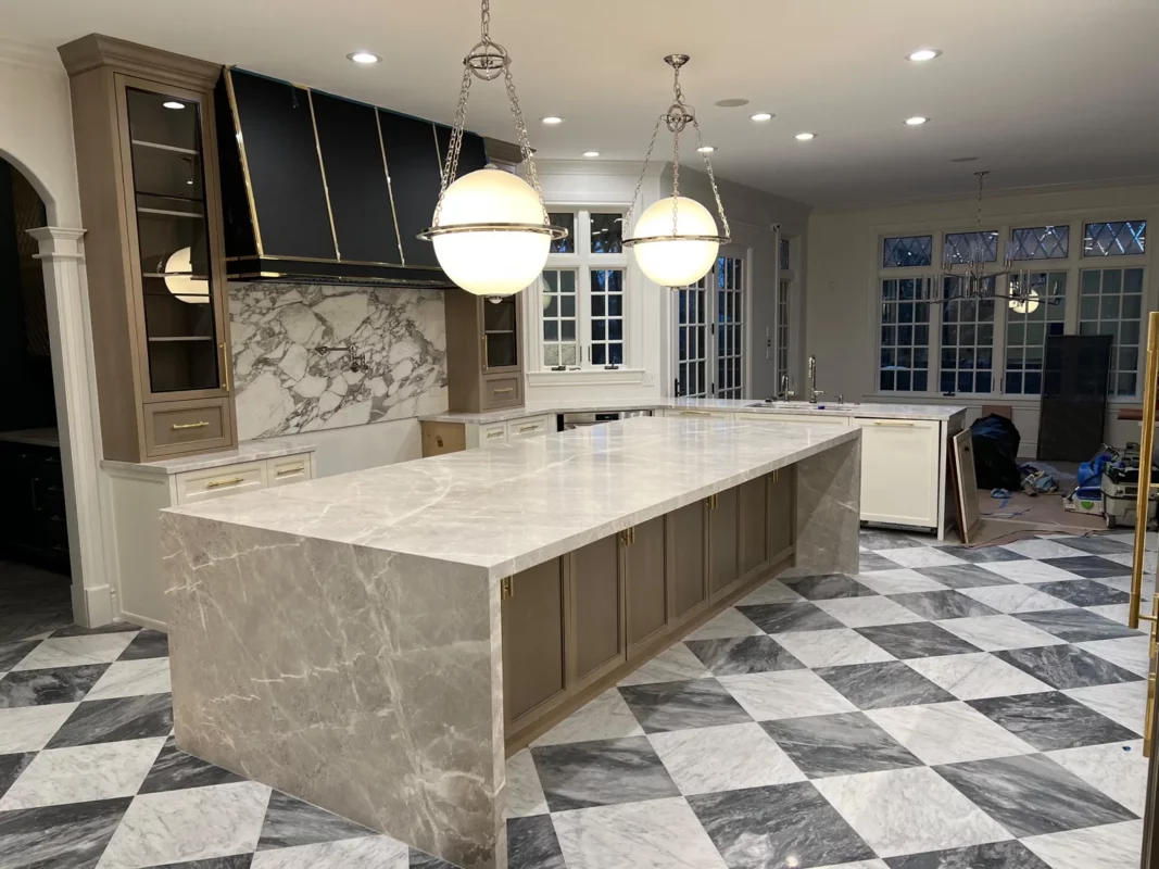 Kitchen remodel with a central island, globe pendants and a checkered floor.